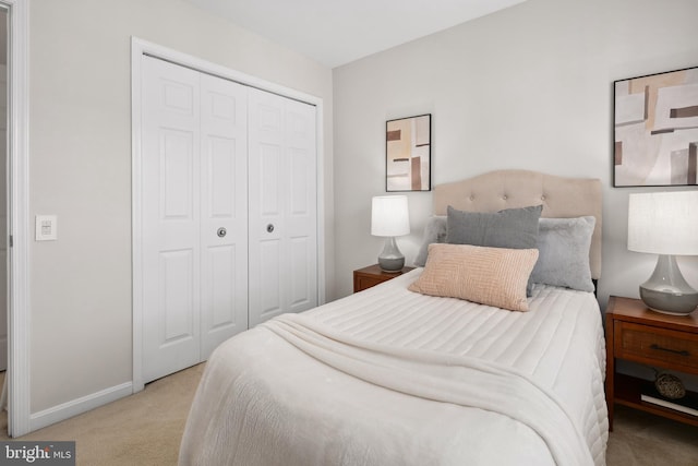 bedroom featuring a closet, carpet floors, and baseboards