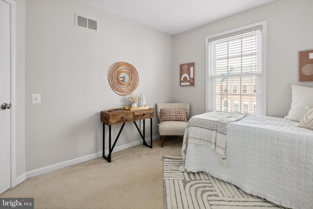 carpeted bedroom with baseboards and visible vents