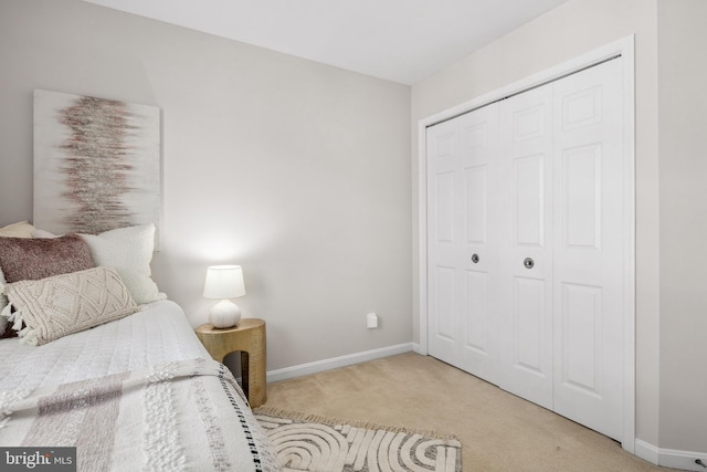 bedroom with a closet, baseboards, and carpet floors