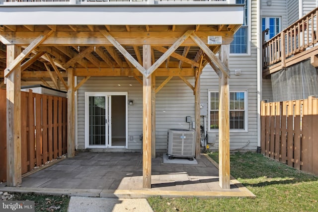 view of patio featuring cooling unit and fence