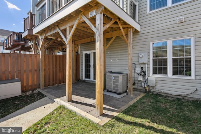 view of patio / terrace with cooling unit and fence