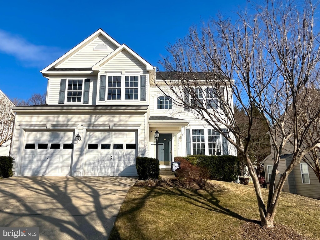 traditional-style house with a garage and concrete driveway