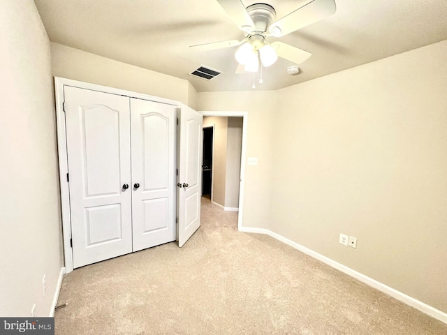 unfurnished bedroom featuring visible vents, ceiling fan, baseboards, light carpet, and a closet