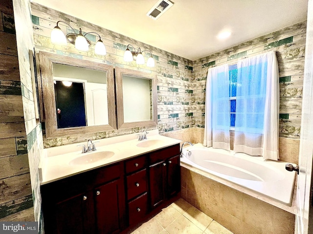 bathroom featuring double vanity, a garden tub, visible vents, and a sink