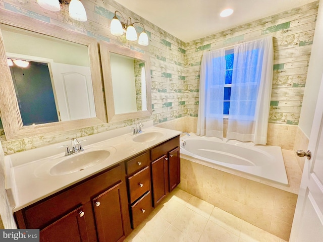 full bath featuring double vanity, tile patterned floors, tiled bath, and a sink