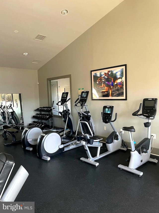 gym featuring visible vents and lofted ceiling