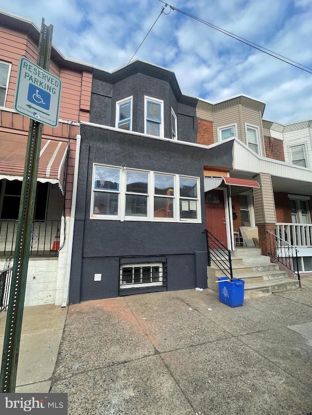 view of property featuring entry steps and stucco siding