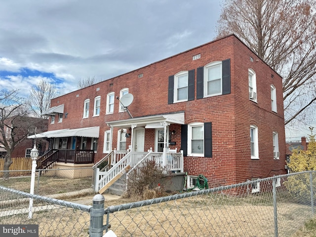 view of property featuring a fenced front yard and brick siding