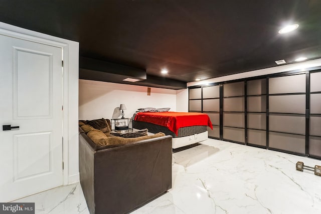 bedroom featuring recessed lighting and marble finish floor