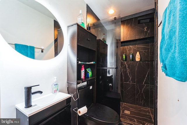 bathroom featuring a walk in shower and vanity