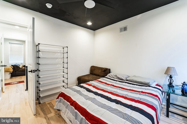 bedroom featuring visible vents, ceiling fan, and light wood finished floors