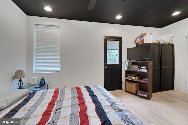 bedroom with recessed lighting and light wood-style floors