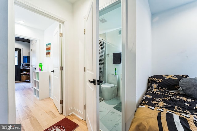 bathroom with toilet and wood finished floors