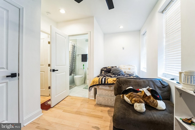 interior space with a ceiling fan, ensuite bath, recessed lighting, and light wood finished floors