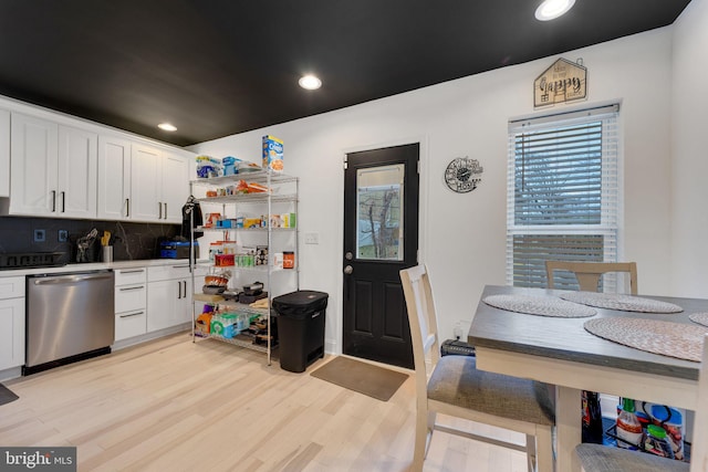 kitchen featuring backsplash, recessed lighting, light wood-style flooring, white cabinets, and stainless steel dishwasher