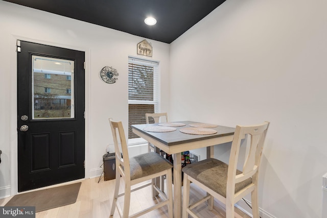 dining space with recessed lighting, baseboards, and light wood-type flooring