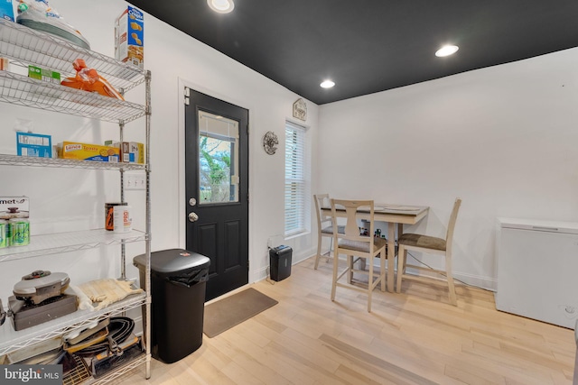 interior space featuring recessed lighting, wood finished floors, and baseboards