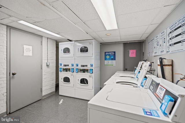 shared laundry area featuring stacked washing maching and dryer and washing machine and clothes dryer