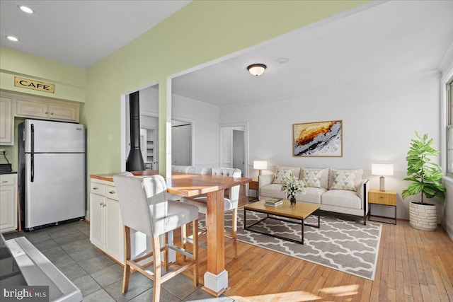 dining room featuring recessed lighting, crown molding, and light wood finished floors