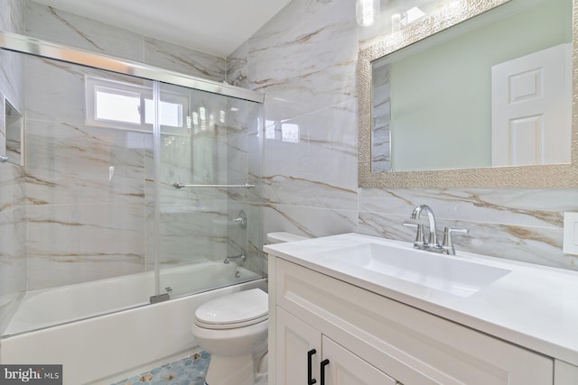 full bath with toilet, bath / shower combo with glass door, vanity, tile walls, and backsplash