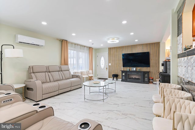 living area featuring marble finish floor, a wall unit AC, a glass covered fireplace, and recessed lighting