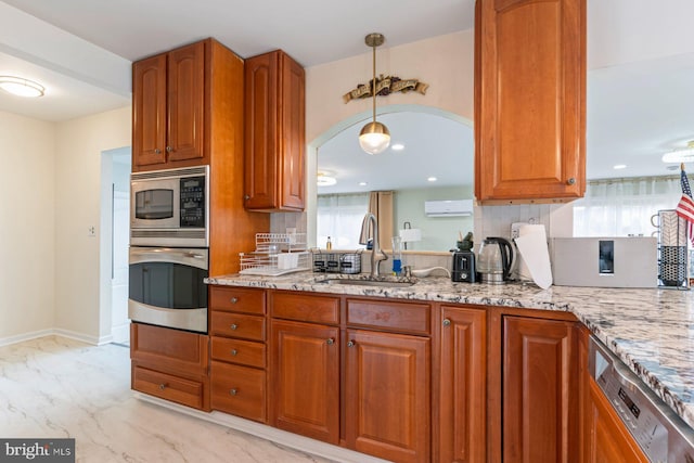 kitchen with appliances with stainless steel finishes, marble finish floor, a sink, and light stone counters