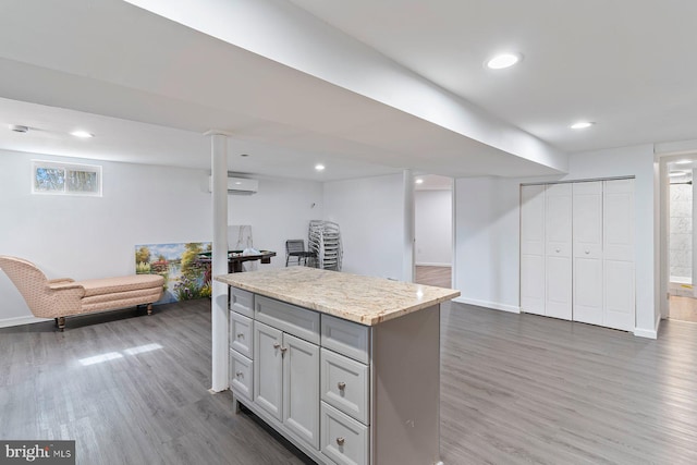 kitchen featuring a center island, open floor plan, recessed lighting, and wood finished floors