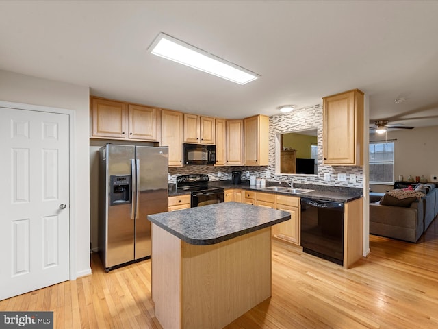 125 Monticello Sq, Winchester, VA 22602 - kitchen with light brown cabinetry, black appliances, dark countertops, and a sink