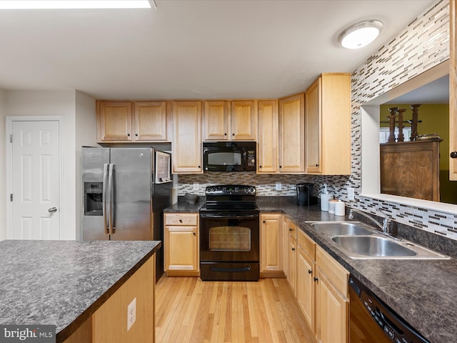 125 Monticello Sq, Winchester, VA 22602 - kitchen with black appliances, light wood-style flooring, a sink, backsplash, and dark countertops