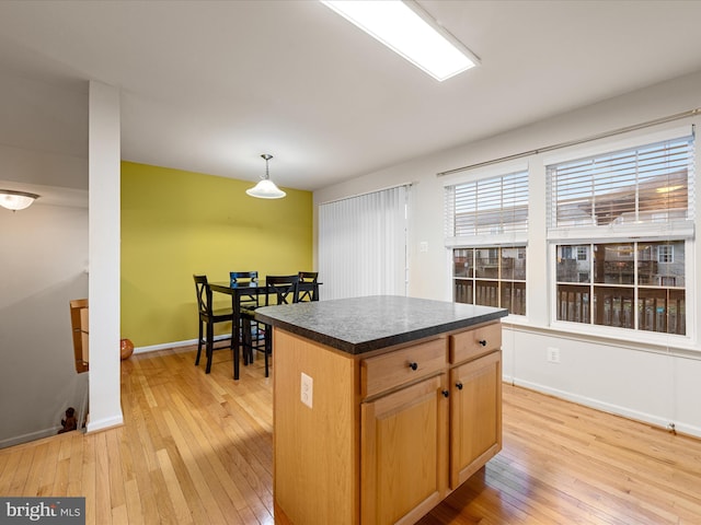 125 Monticello Sq, Winchester, VA 22602 - kitchen featuring baseboards, dark countertops, a center island, and light wood finished floors