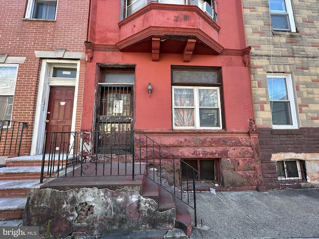 doorway to property featuring brick siding and stone siding