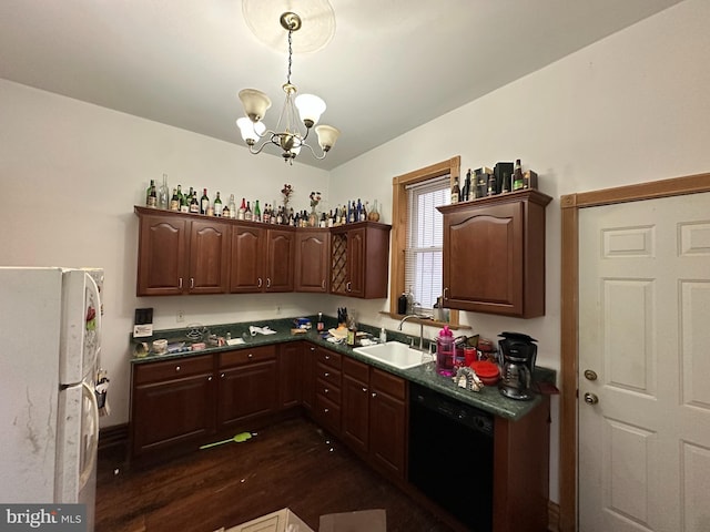 kitchen featuring freestanding refrigerator, a sink, dark wood-type flooring, black dishwasher, and dark countertops