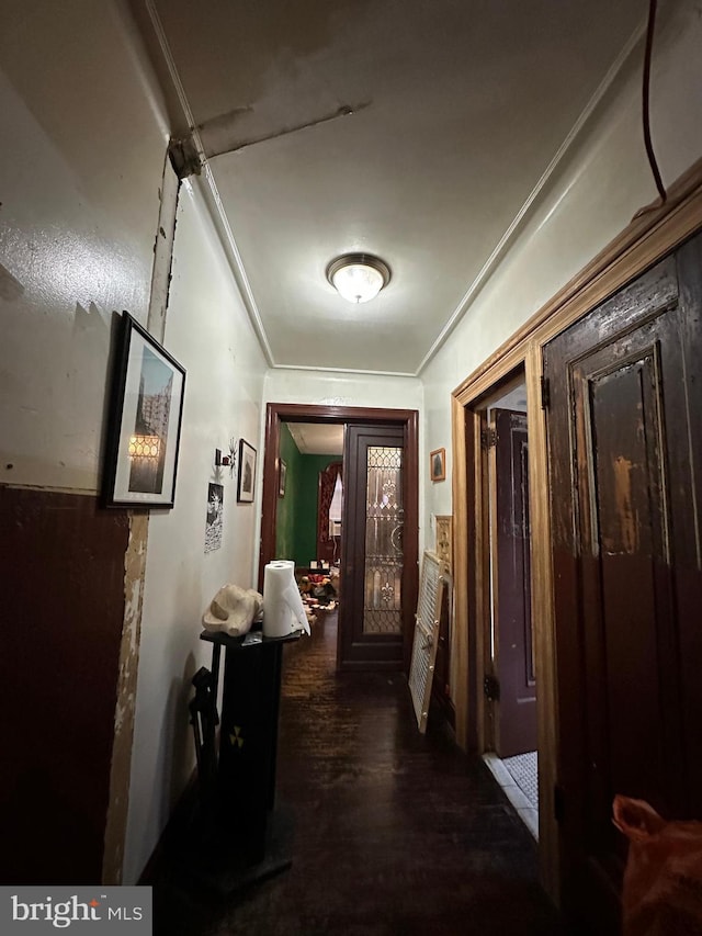 hall featuring wood finished floors and ornamental molding