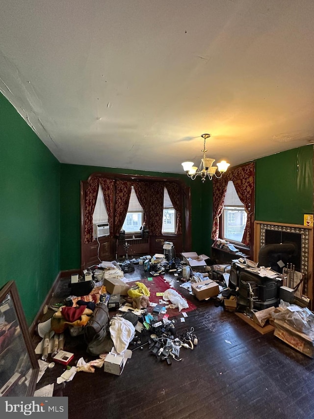 miscellaneous room featuring a wealth of natural light, cooling unit, wood finished floors, and a chandelier