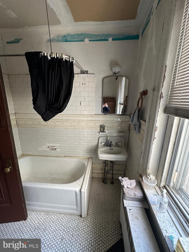 full bathroom with a sink and tile patterned flooring