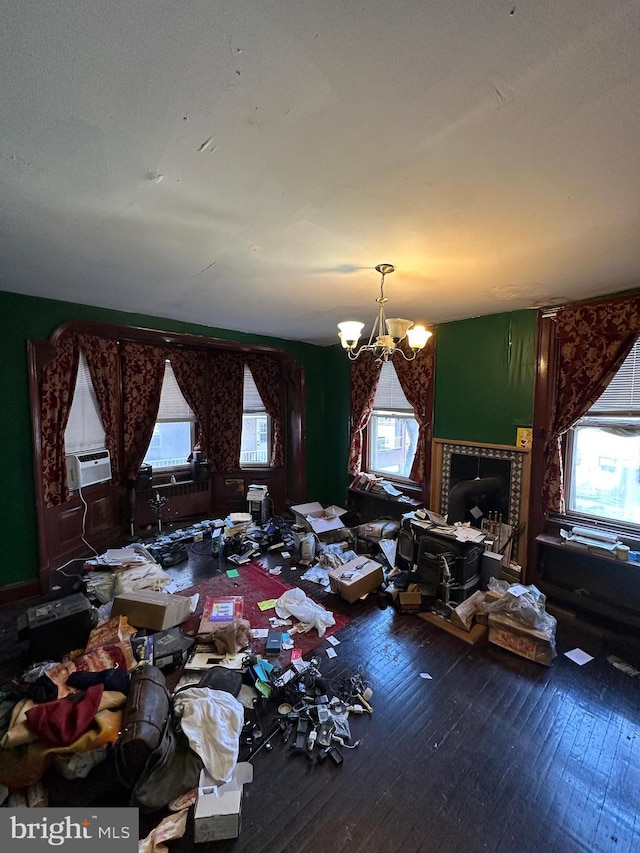 miscellaneous room featuring cooling unit, a notable chandelier, and hardwood / wood-style floors