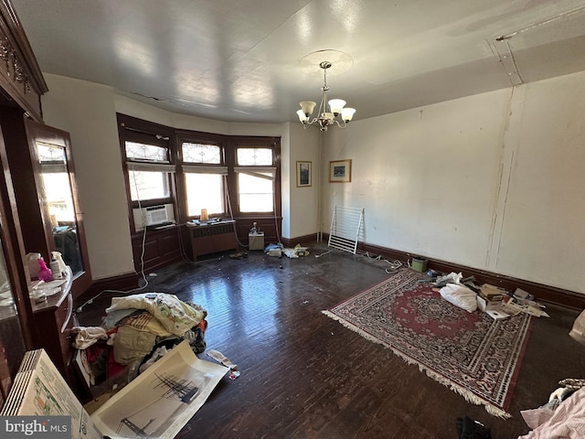 dining room with an inviting chandelier, cooling unit, wood finished floors, and baseboards