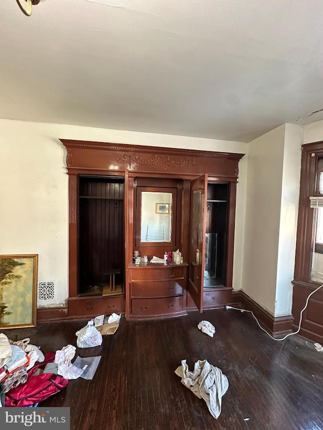 dining room featuring visible vents, baseboards, and wood finished floors