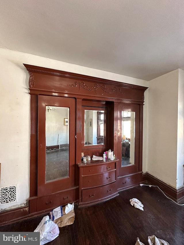 details featuring wood finished floors and baseboards