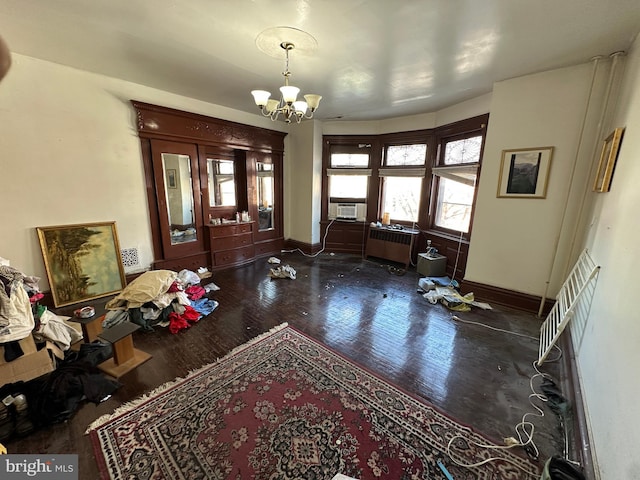 foyer entrance featuring radiator, baseboards, a chandelier, cooling unit, and wood finished floors