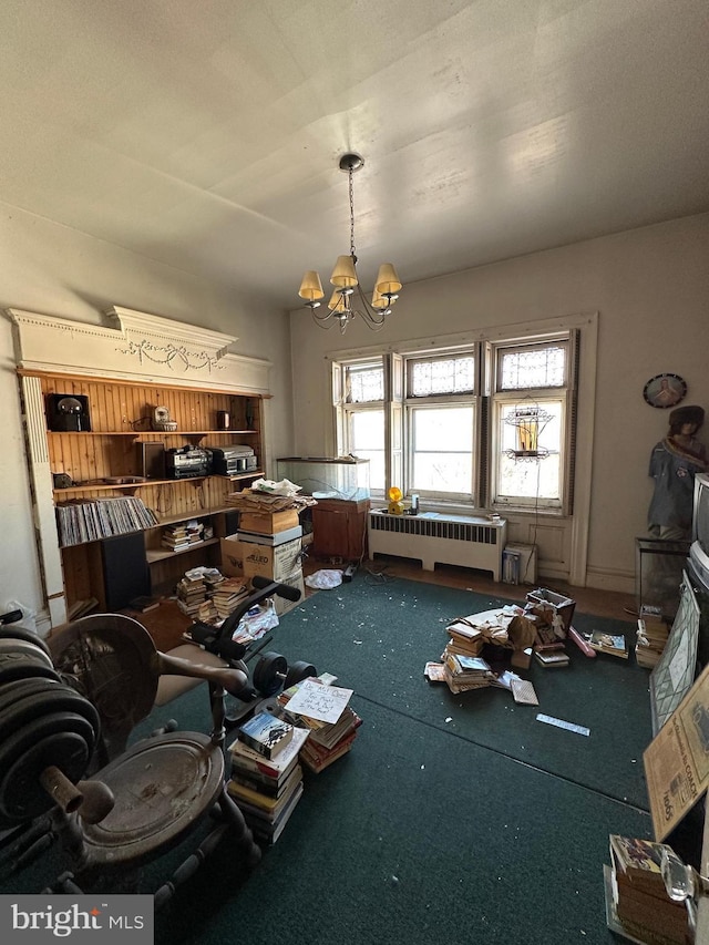 miscellaneous room featuring radiator and a chandelier