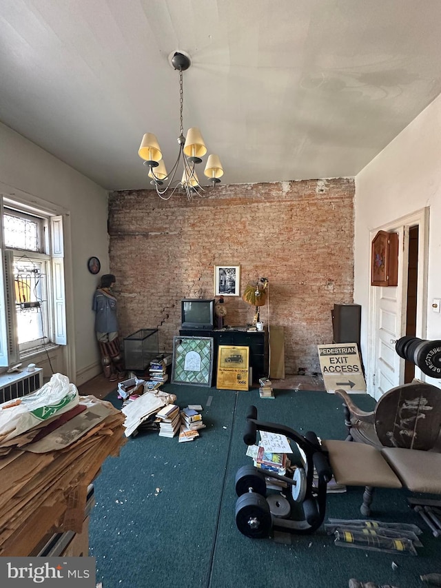 unfurnished dining area with a notable chandelier and brick wall