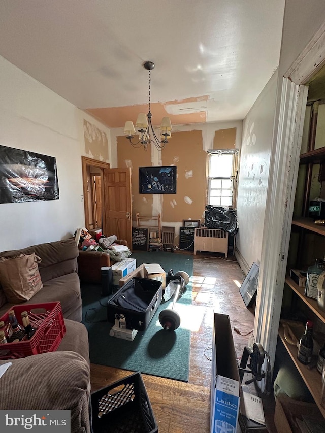 living room featuring radiator and an inviting chandelier