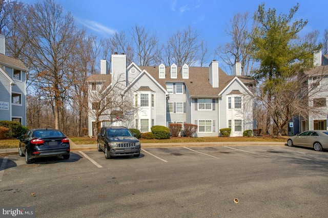 exterior space featuring uncovered parking and a residential view