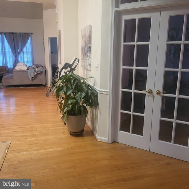hall featuring french doors and wood finished floors