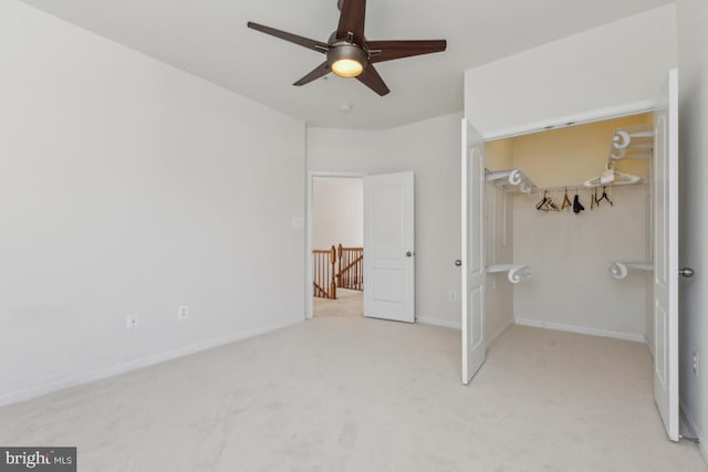 unfurnished bedroom featuring a closet, ceiling fan, baseboards, and carpet floors