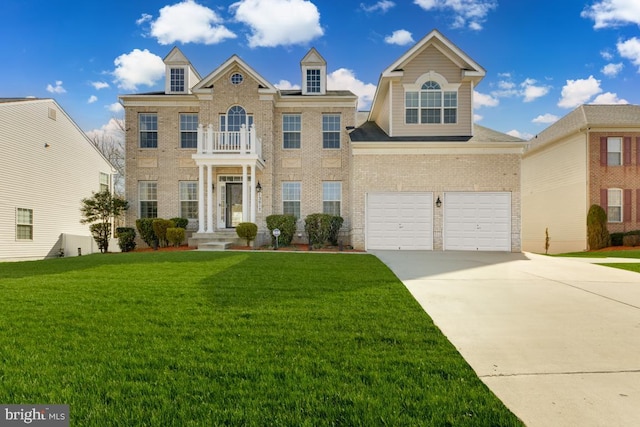 georgian-style home with brick siding, an attached garage, a front yard, a balcony, and driveway