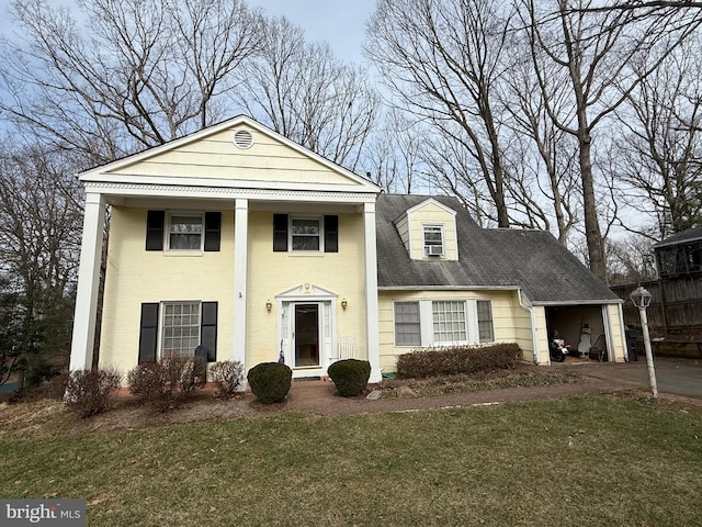 greek revival inspired property with a front lawn