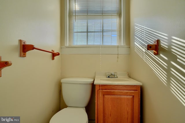 half bathroom featuring toilet and vanity