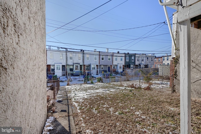 view of yard with fence and a residential view